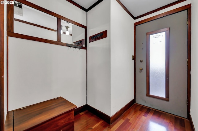 foyer entrance with baseboards, wood finished floors, and crown molding