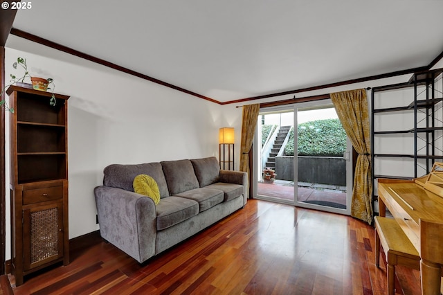 living area featuring stairway, wood finished floors, and ornamental molding