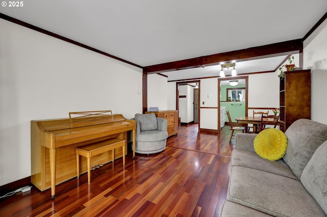 living area with beam ceiling, wood finished floors, baseboards, and ornamental molding