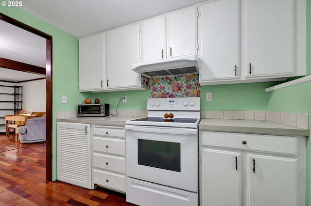 kitchen featuring under cabinet range hood, electric range, white cabinets, and light countertops