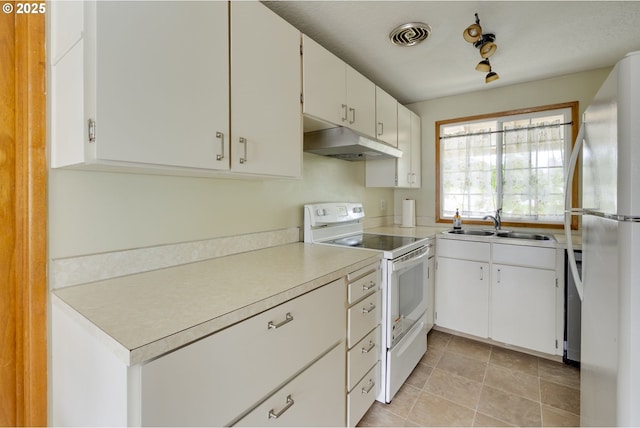 3441 SE 162nd Ave, Portland, OR 97236 - kitchen featuring white appliances, under cabinet range hood, light countertops, and white cabinetry