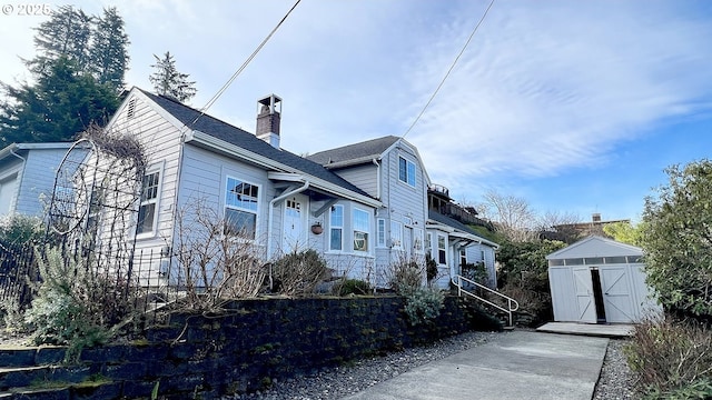 1125 16th St, Astoria, OR 97103 - view of front of property with a shed, an outbuilding, and a chimney