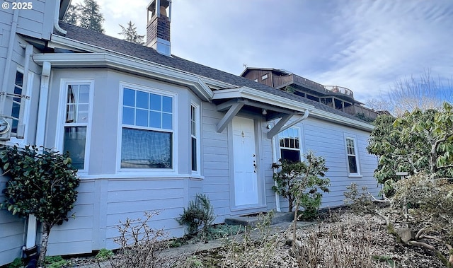 1125 16th St, Astoria, OR 97103 - view of home's exterior with a shingled roof and a chimney