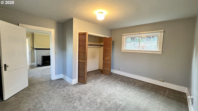 1125 16th St, Astoria, OR 97103 - unfurnished bedroom featuring carpet flooring, a closet, a fireplace, and baseboards