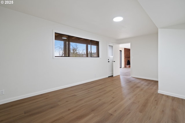 spare room featuring wood finished floors and baseboards