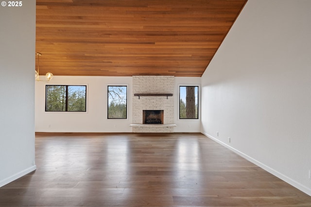 unfurnished living room with baseboards, a fireplace, wooden ceiling, wood finished floors, and high vaulted ceiling