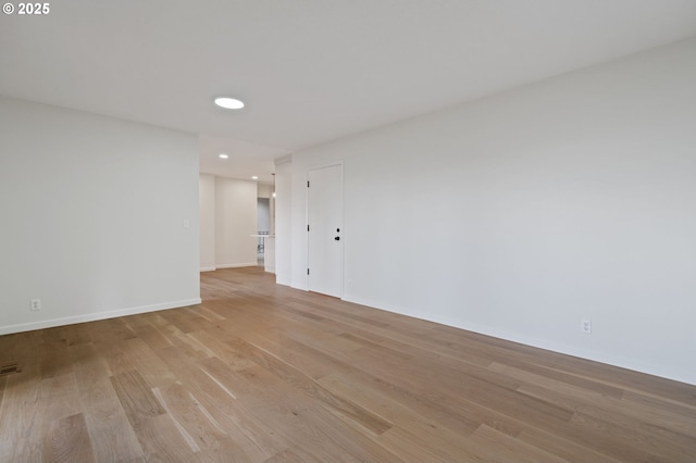 unfurnished room with recessed lighting, light wood-style floors, and baseboards