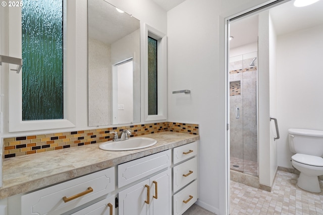 136 Del Prado St, Lake Oswego, OR 97035 - full bathroom featuring toilet, a stall shower, vanity, decorative backsplash, and baseboards