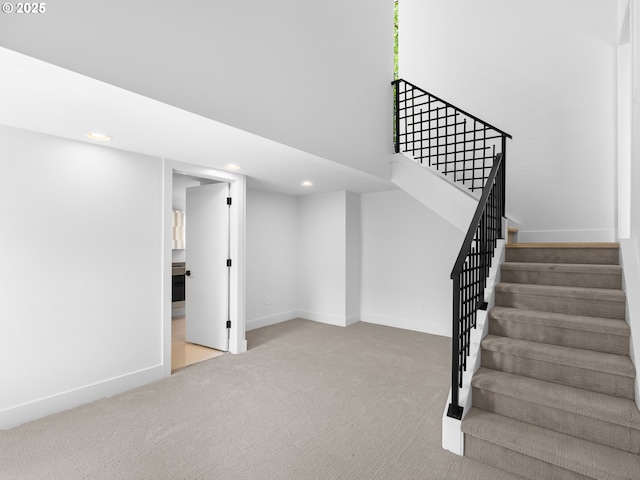 stairs with recessed lighting, baseboards, and carpet floors