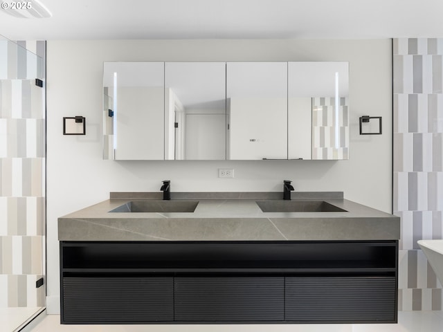 full bathroom with double vanity, visible vents, and a sink