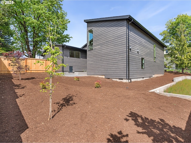 back of property featuring fence