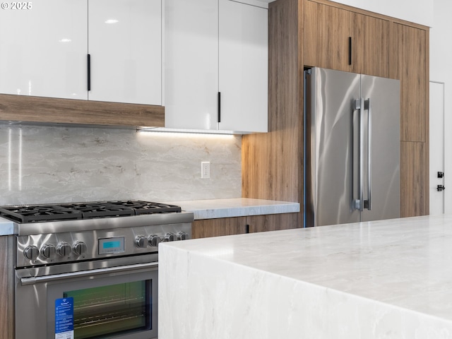 kitchen with brown cabinets, high end appliances, ventilation hood, modern cabinets, and backsplash