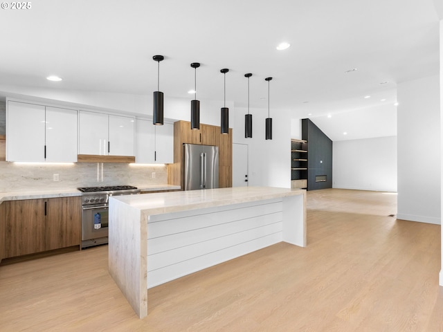 kitchen featuring premium appliances, modern cabinets, and recessed lighting