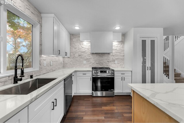 3612 NE 111th St, Vancouver, WA 98686 - kitchen with appliances with stainless steel finishes, a sink, wall chimney exhaust hood, light stone counters, and backsplash