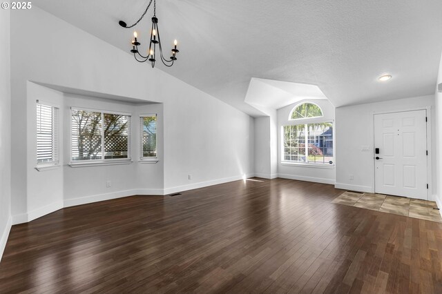 3612 NE 111th St, Vancouver, WA 98686 - unfurnished living room featuring vaulted ceiling, a chandelier, wood finished floors, and baseboards