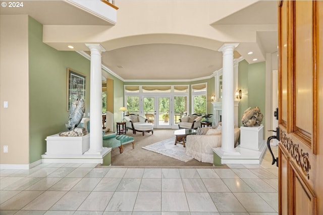 foyer featuring ornate columns, recessed lighting, baseboards, ornamental molding, and light colored carpet