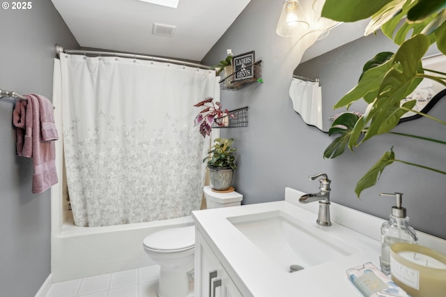 full bathroom featuring shower / bath combination with curtain, vanity, toilet, and a skylight