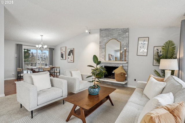 living room featuring a chandelier, vaulted ceiling, and a brick fireplace