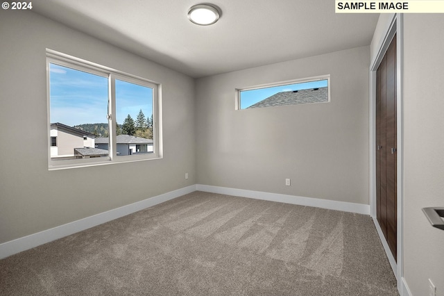 unfurnished bedroom featuring a closet, baseboards, and carpet flooring