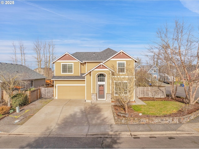 traditional-style house with concrete driveway, roof with shingles, fence, and an attached garage