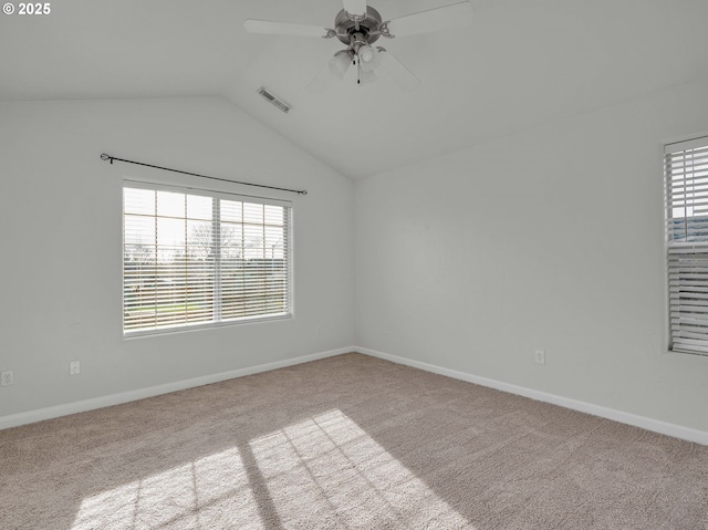 spare room with baseboards, visible vents, a ceiling fan, light colored carpet, and lofted ceiling