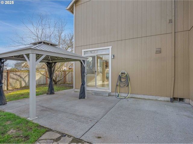 view of patio / terrace featuring fence and a gazebo