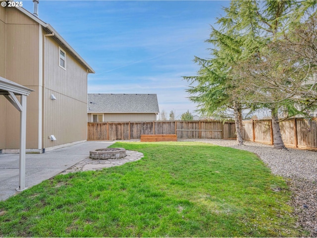 view of yard with a patio, an outdoor fire pit, and a fenced backyard