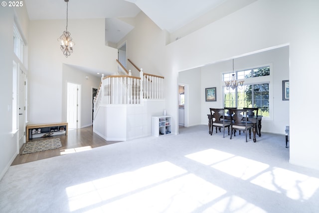 interior space featuring stairs, an inviting chandelier, and a high ceiling