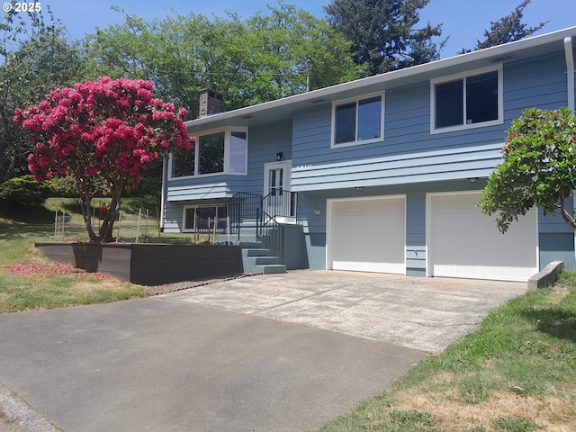 4810 SW 48th Ct, Lincoln City, OR 97367 - split foyer home with an attached garage, driveway, and a chimney
