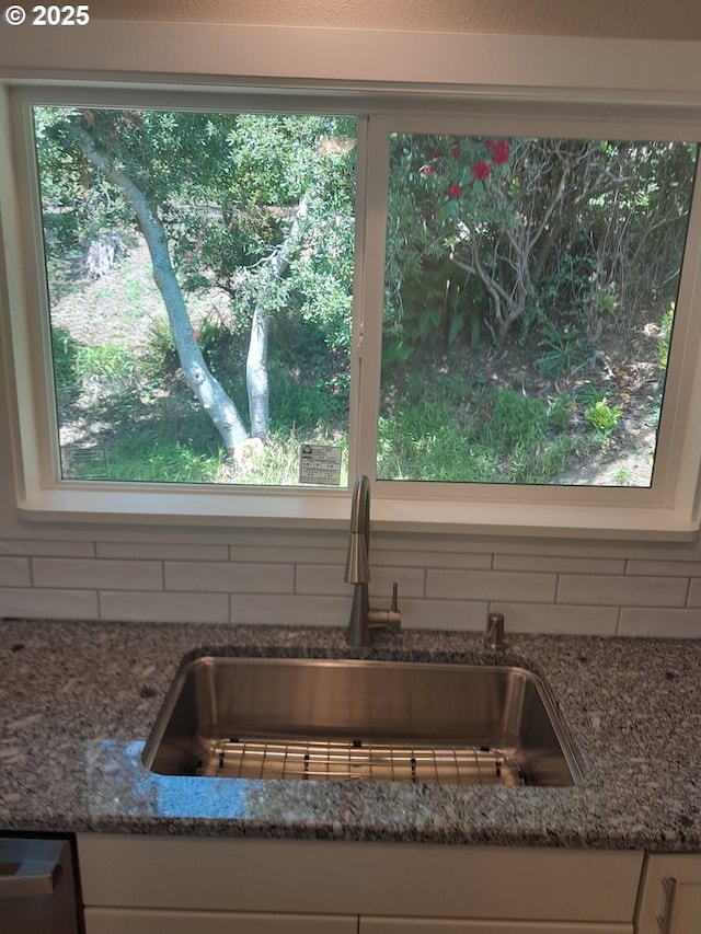 4810 SW 48th Ct, Lincoln City, OR 97367 - kitchen view of a sink, backsplash, white cabinets, and light stone countertops