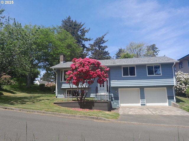 4810 SW 48th Ct, Lincoln City, OR 97367 - bi-level home with a garage, a chimney, driveway, and a front lawn