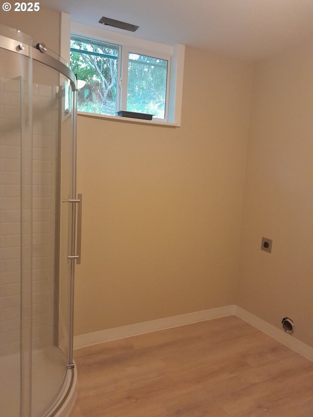4810 SW 48th Ct, Lincoln City, OR 97367 - bathroom featuring wood finished floors, a stall shower, and baseboards