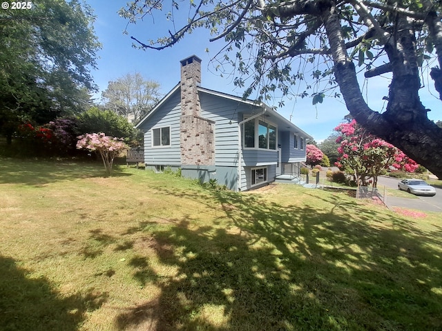 4810 SW 48th Ct, Lincoln City, OR 97367 - view of property exterior featuring a chimney and a lawn