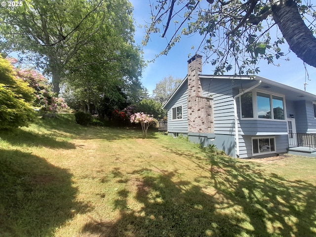 4810 SW 48th Ct, Lincoln City, OR 97367 - view of side of property featuring a chimney and a lawn
