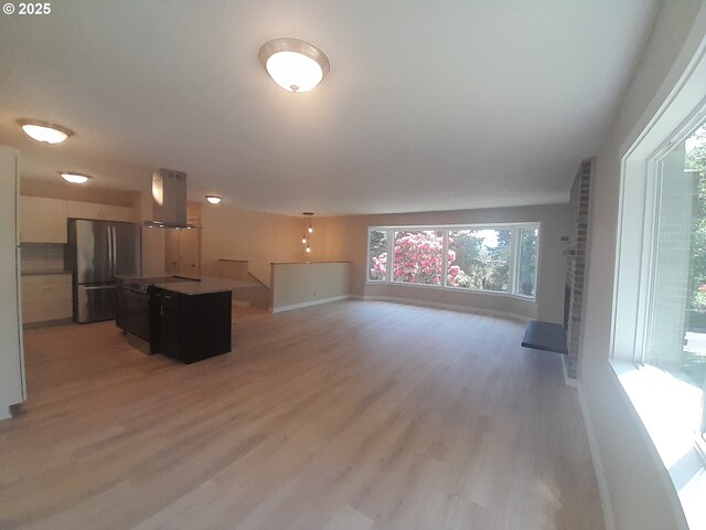 4810 SW 48th Ct, Lincoln City, OR 97367 - unfurnished living room with light wood-style floors and baseboards