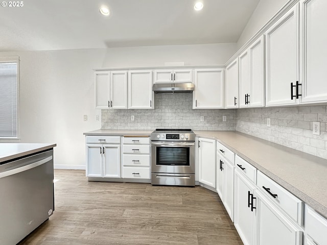 1916 SW 6th St, Battle Ground, WA 98604 - kitchen featuring stainless steel appliances, under cabinet range hood, backsplash, white cabinetry, and recessed lighting
