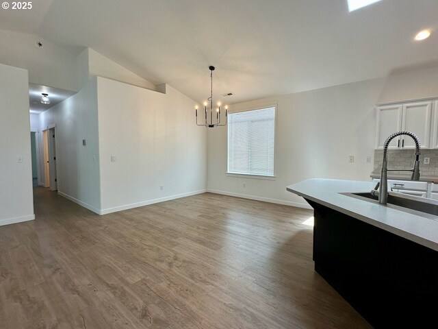 1916 SW 6th St, Battle Ground, WA 98604 - unfurnished dining area with a chandelier, wood finished floors, vaulted ceiling, and recessed lighting
