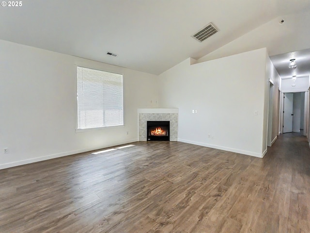 1916 SW 6th St, Battle Ground, WA 98604 - unfurnished living room featuring wood finished floors, vaulted ceiling, and a tile fireplace