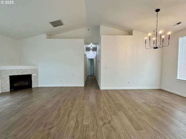 1916 SW 6th St, Battle Ground, WA 98604 - unfurnished living room featuring a chandelier, wood finished floors, vaulted ceiling, and a fireplace