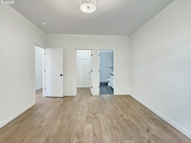 1916 SW 6th St, Battle Ground, WA 98604 - unfurnished bedroom with light wood-style flooring, a spacious closet, a closet, and ensuite bath