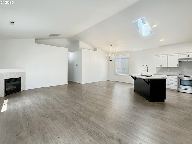 1916 SW 6th St, Battle Ground, WA 98604 - living area with lofted ceiling, a chandelier, a skylight, light wood-style flooring, and a fireplace