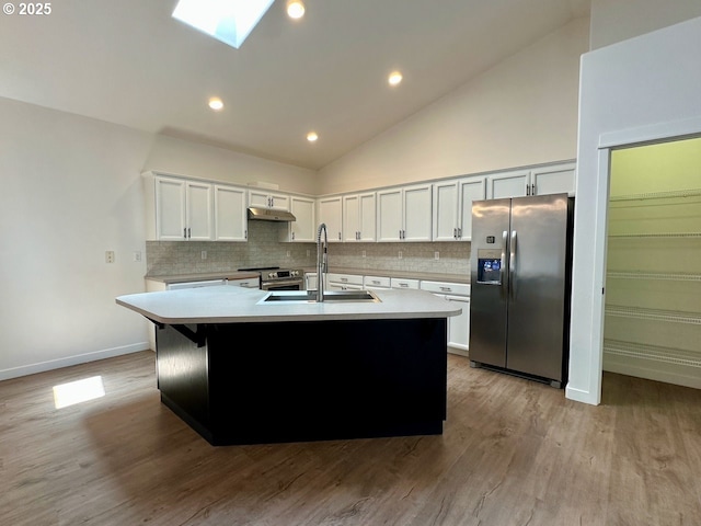 1916 SW 6th St, Battle Ground, WA 98604 - kitchen with stainless steel appliances, under cabinet range hood, backsplash, lofted ceiling, and light countertops