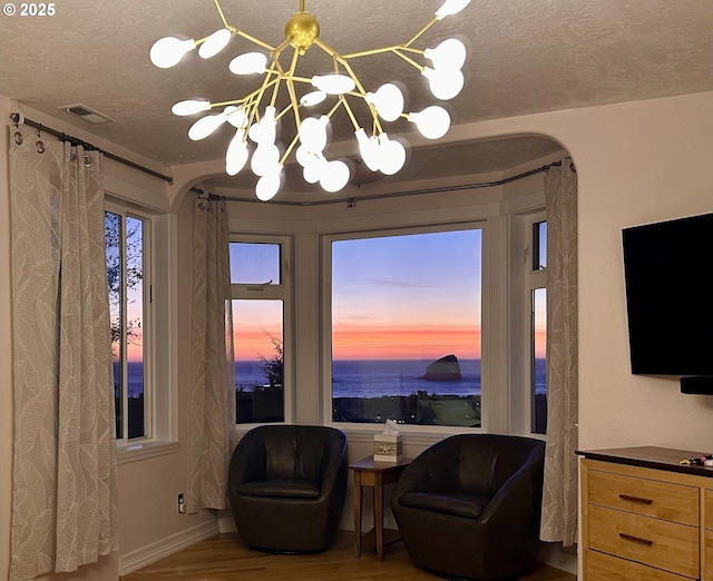 35445 Topping Rd, Pacific City, OR 97135 - sitting room with wood finished floors, visible vents, arched walkways, and a textured ceiling