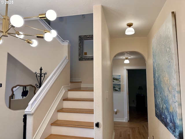 35445 Topping Rd, Pacific City, OR 97135 - staircase featuring arched walkways and a notable chandelier