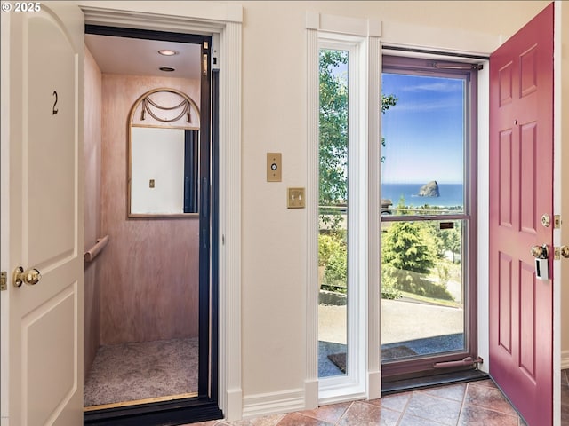35445 Topping Rd, Pacific City, OR 97135 - doorway to outside featuring tile patterned flooring, baseboards, elevator, and a water view