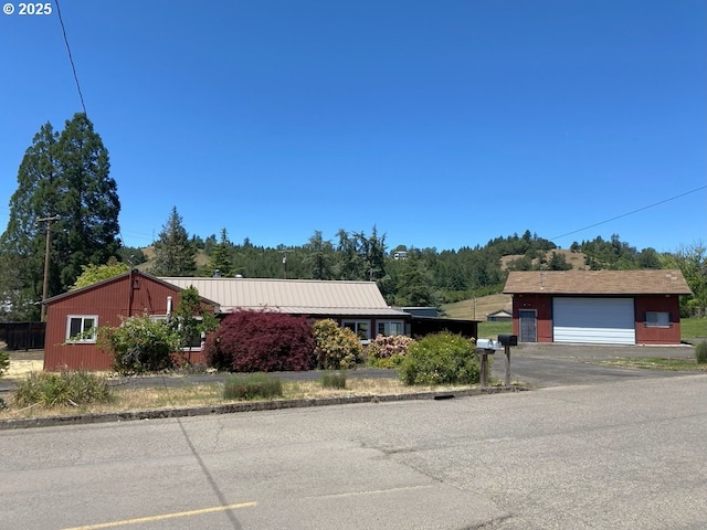 1223 NE Locust St, Oakland, OR 97462 - single story home with a detached garage, an outdoor structure, and metal roof
