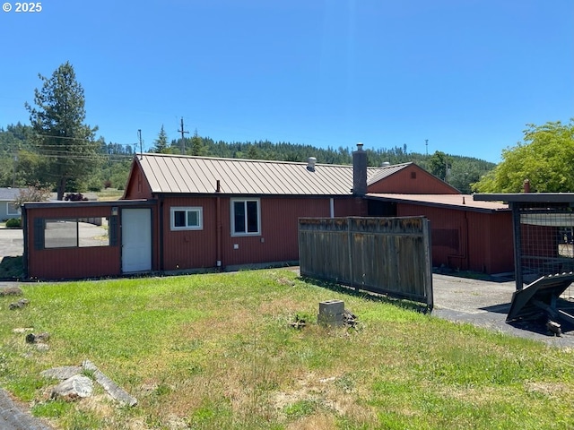 1223 NE Locust St, Oakland, OR 97462 - back of property with metal roof and a lawn