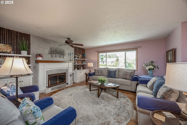 4405 NE 29th Ave, Vancouver, WA 98663 - living room featuring ceiling fan, a tile fireplace, wood finished floors, and a textured ceiling
