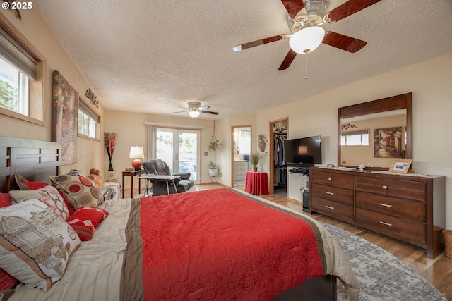 4405 NE 29th Ave, Vancouver, WA 98663 - bedroom with a textured ceiling, multiple windows, light wood-style floors, and access to outside