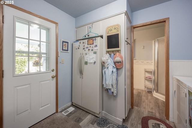 4405 NE 29th Ave, Vancouver, WA 98663 - entryway with wood finished floors, washer and dryer, and wainscoting